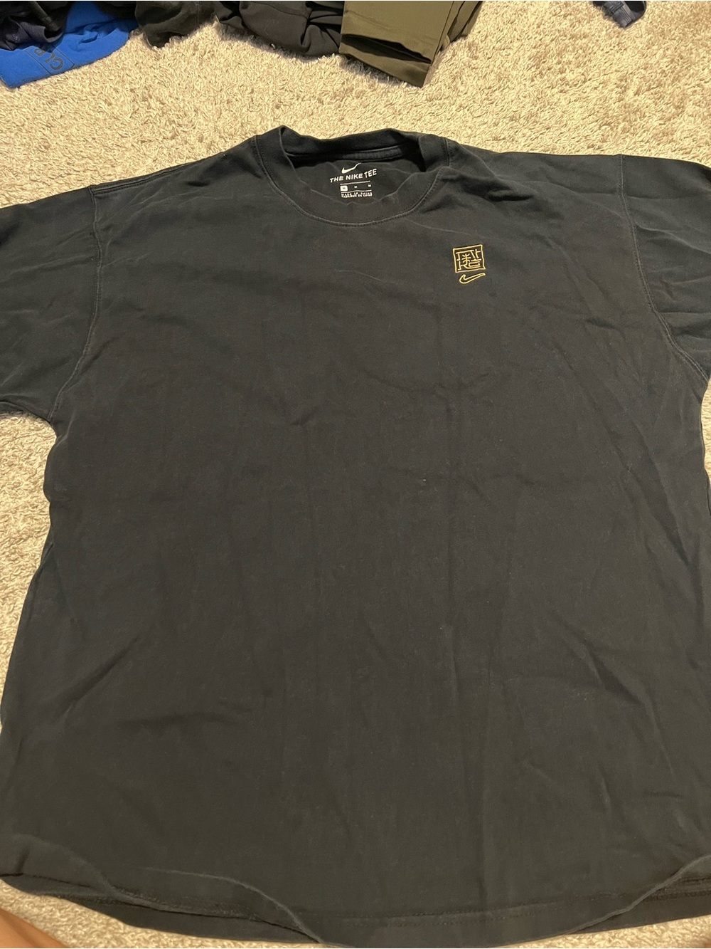 Nike Black Short-Sleeve Tee with Gold Logo Accent